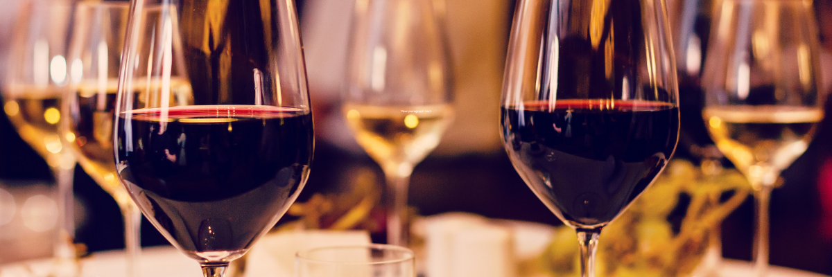 Wine glasses lined up in a close up shot with the background blurred